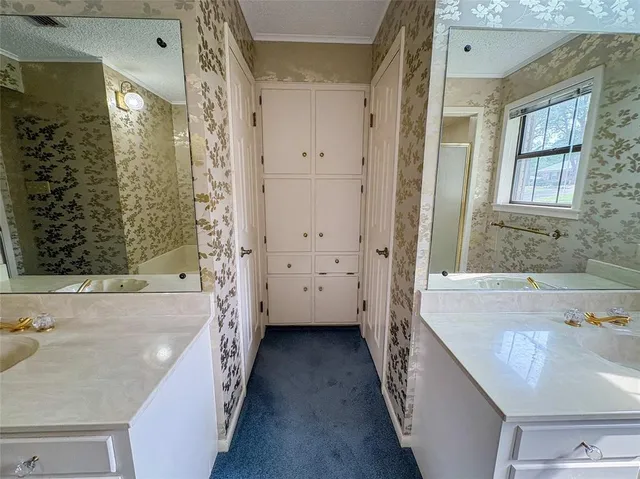 a bathroom with a tub sink and mirror