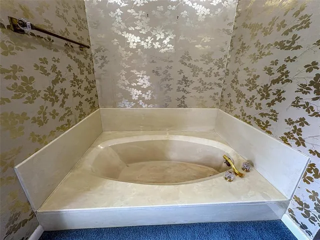 a bath tub sitting in a bathroom next to a sink