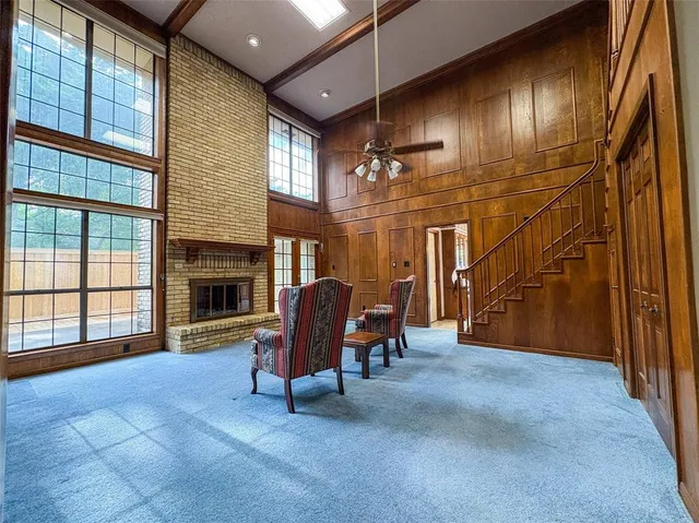 a view of a livingroom with fireplace and furniture