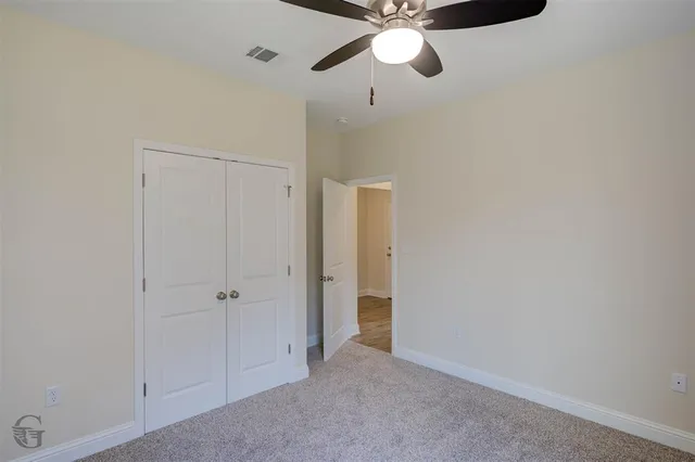 a view of a room with wooden floor and closet
