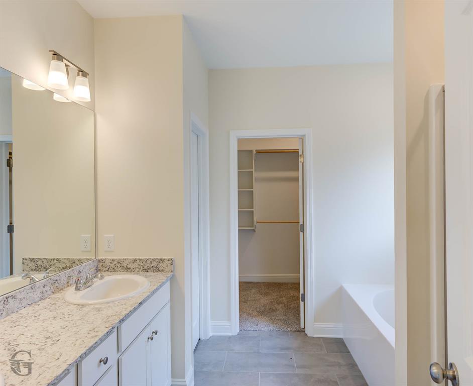 1210 BAYOU BAY Court Frierson, LA 71027 - Photo 18 of 21 a bathroom with a granite countertop sink and a mirror