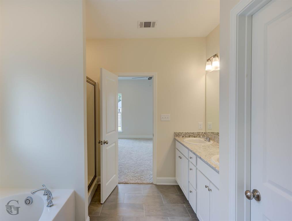 1210 BAYOU BAY Court Frierson, LA 71027 - Photo 19 of 21 a bathroom with a double vanity sink and mirror with shower