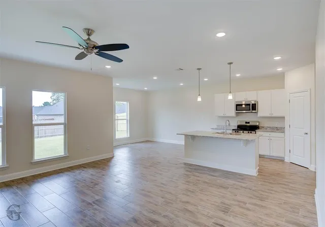 a view of kitchen with sink microwave and stove