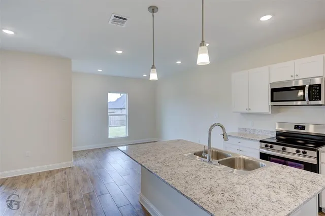 a kitchen with sink and microwave