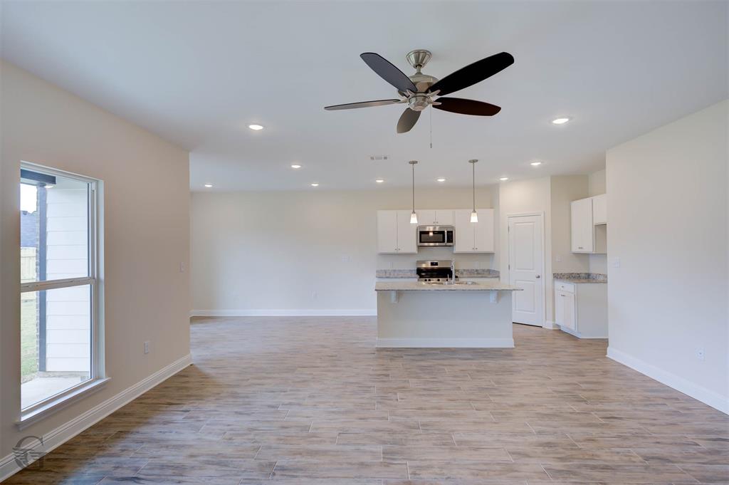 1210 BAYOU BAY Court Frierson, LA 71027 - Photo 8 of 21 a view of kitchen with kitchen island stainless steel appliances wooden floor and window