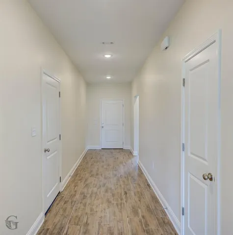 a view of hallway with wooden floor