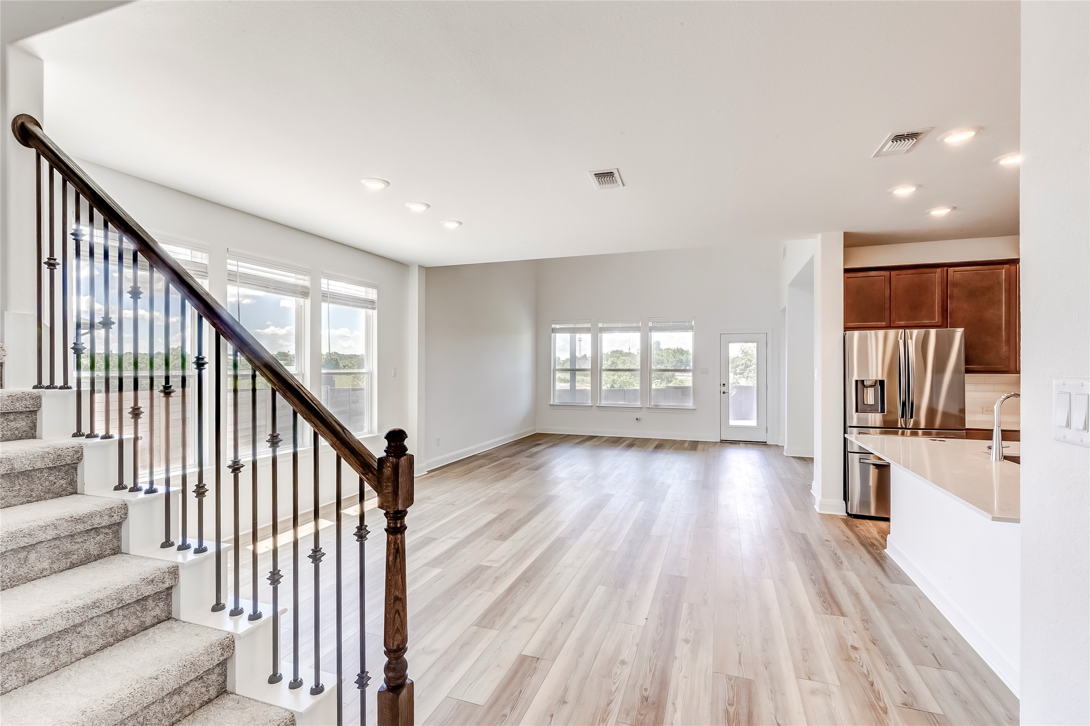 132 Inlet Lane Leander, TX 78641 - Photo 7 of 36 Staircase featuring wood finished floors and recessed lighting