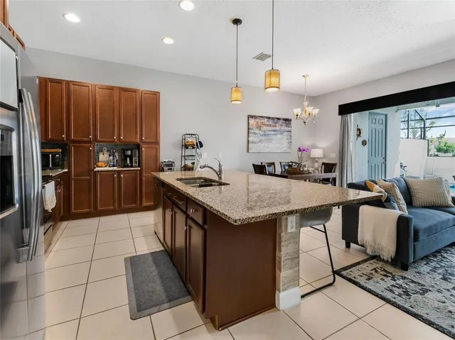 a kitchen with stainless steel appliances granite countertop a sink a stove and a refrigerator