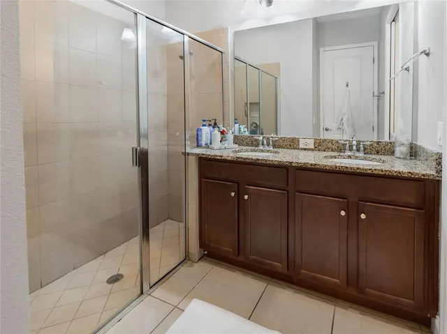 a bathroom with a double vanity sink and mirror