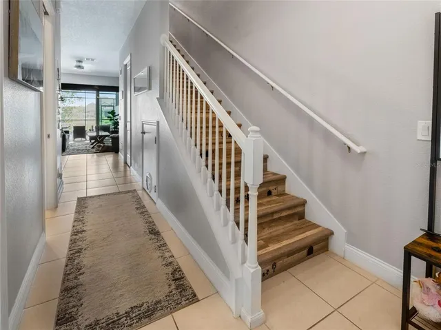 a view of staircase with lots of frames and living room