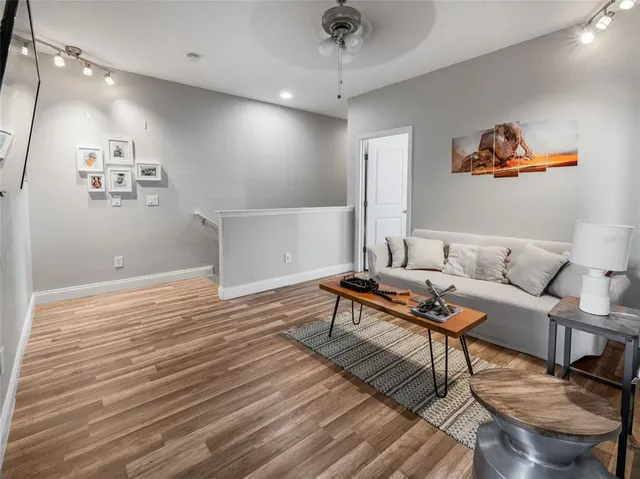 a living room with furniture and a wooden floor