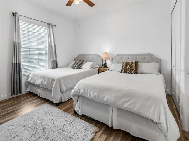 a bedroom with two beds and a window