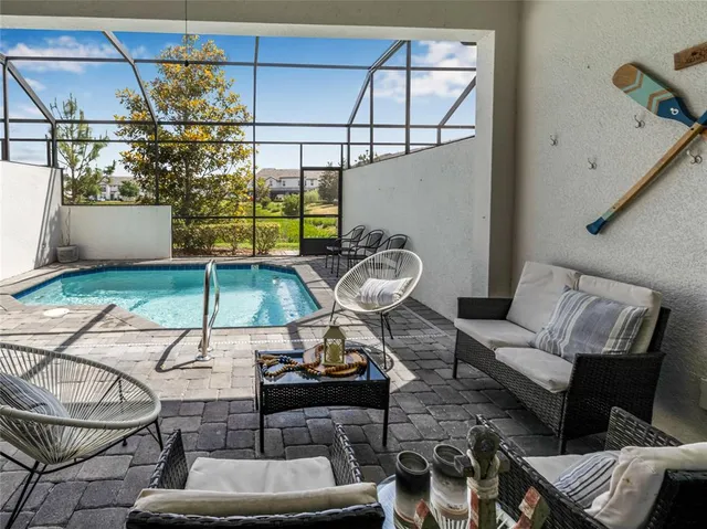 a living room with furniture and a chandelier