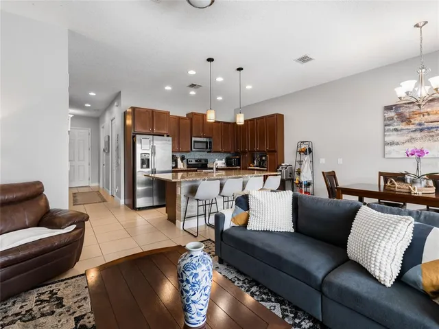 a living room with furniture and kitchen view