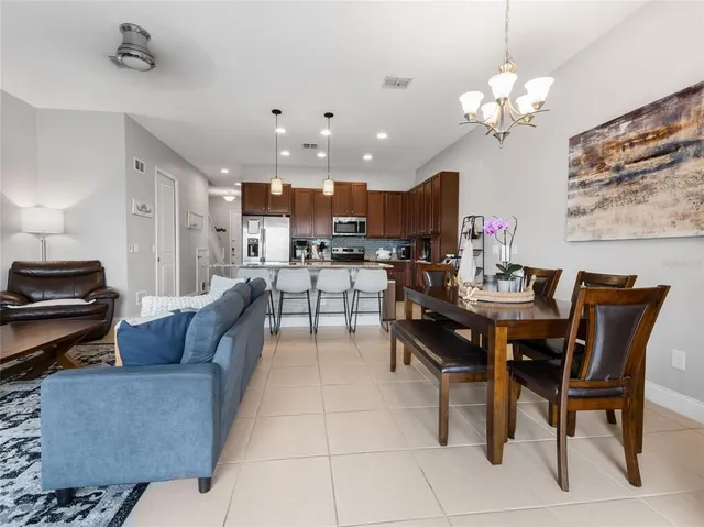 a living room with kitchen furniture and a chandelier