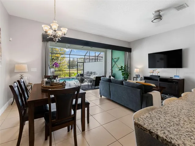 a view of a dining room with furniture and a chandelier