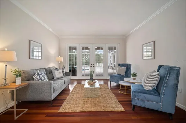 a view of a dining room with furniture a chandelier and wooden floor