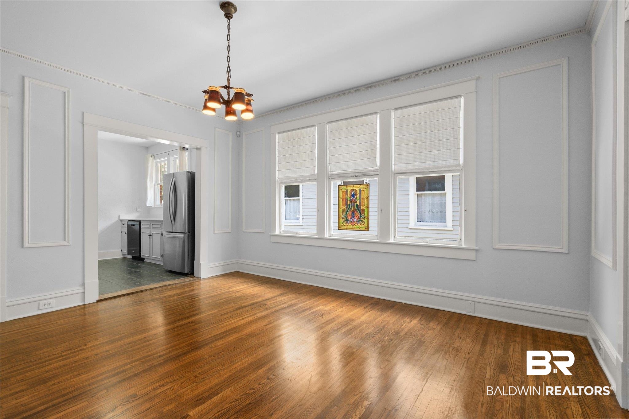 24 Macy Place Mobile, AL 36604 - Photo 10 of 38 Spare room featuring a chandelier, dark wood-type flooring, and baseboards