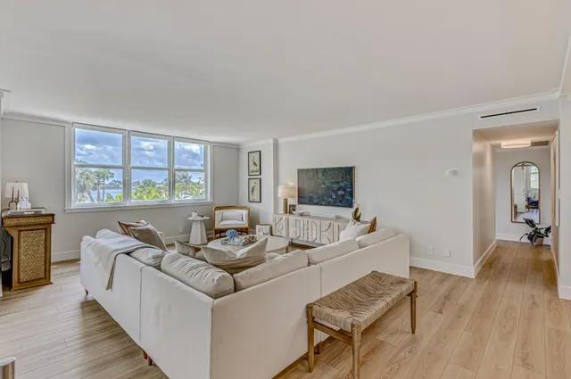 a living room with furniture and a flat screen tv with wooden floor