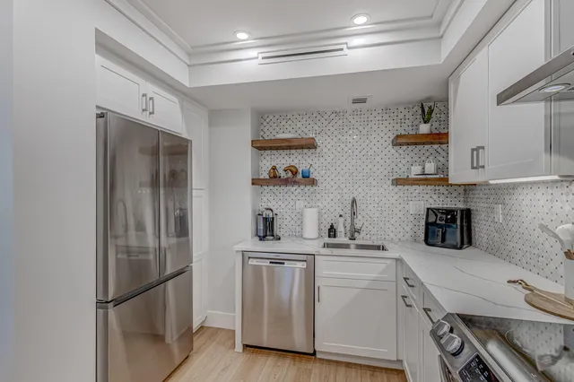 a kitchen with a sink and refrigerator