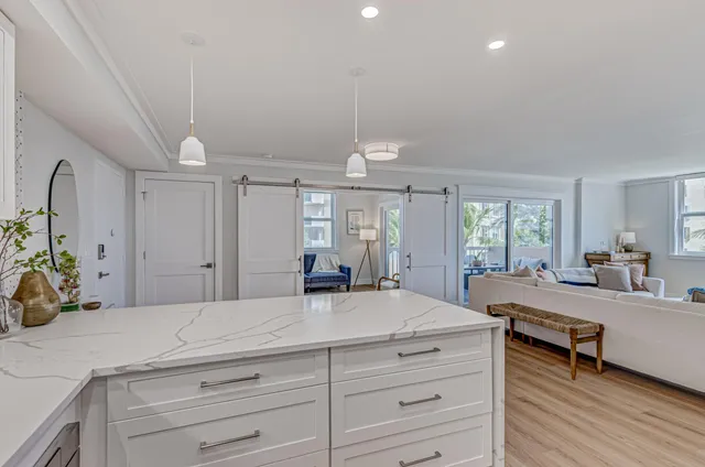 a large bedroom with a bed and a large window