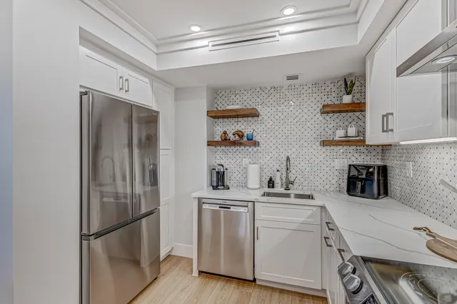 a room with a refrigerator and a sink