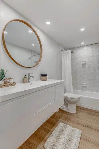 a bathroom with a sink toilet and a mirror