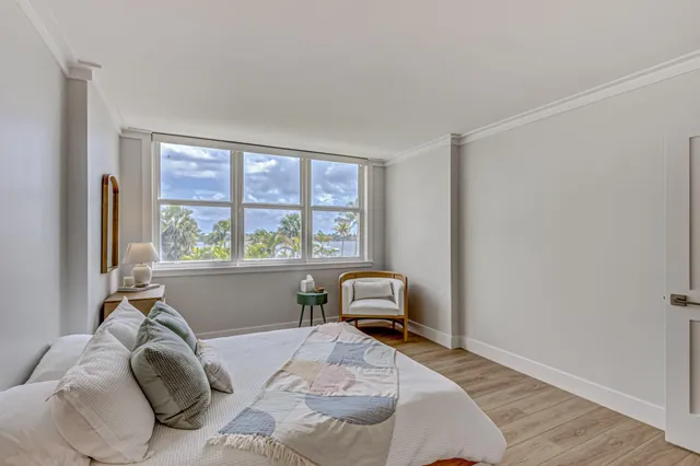 a bed sitting in a bedroom next to a window