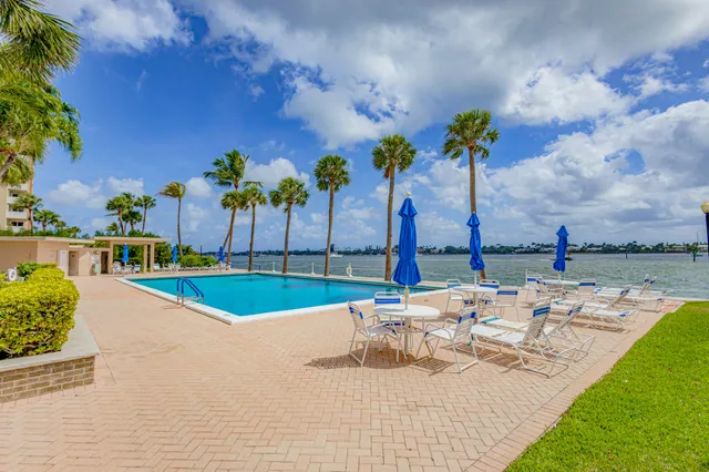 a view of a swimming pool with a table and chairs