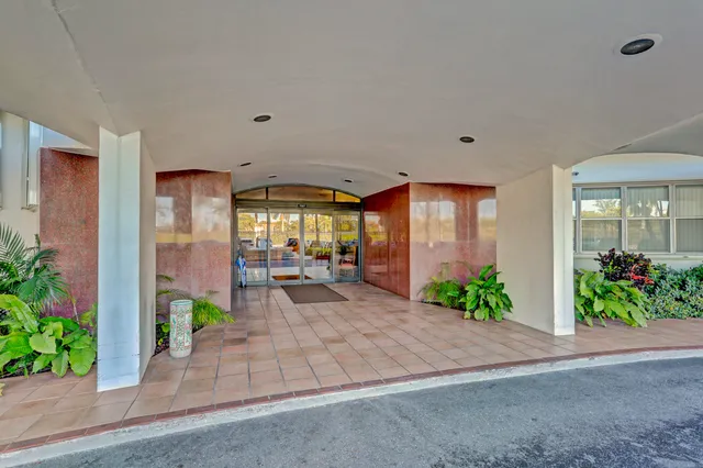 a living room with furniture and a lamp