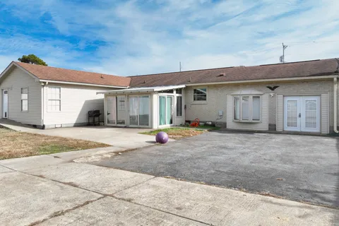 a kitchen with stainless steel appliances kitchen island granite countertop a refrigerator and cabinets