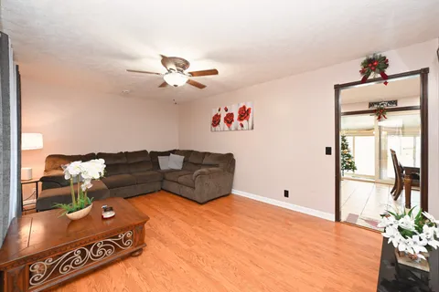 a kitchen with stainless steel appliances kitchen island granite countertop a refrigerator and a sink
