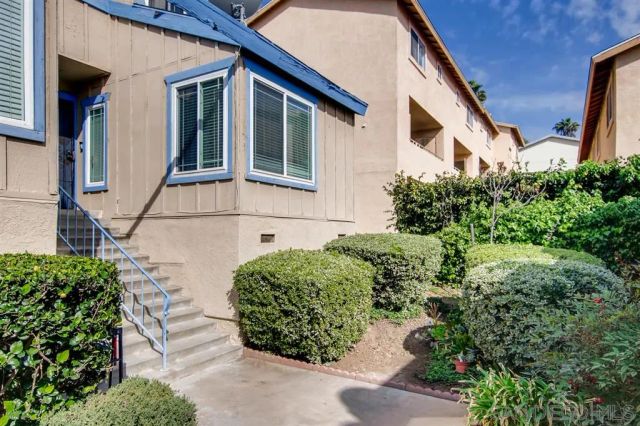 a view of a house with a flower garden