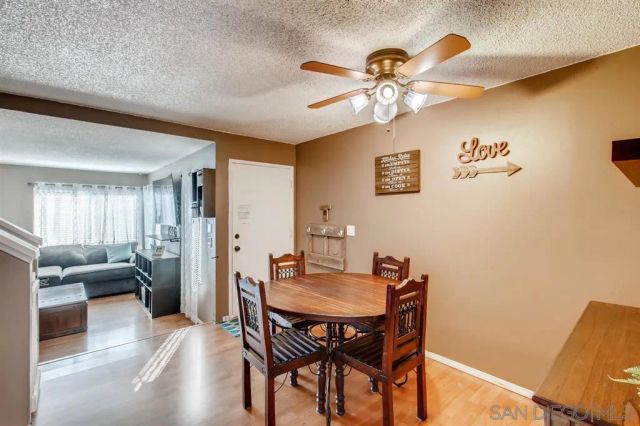 a view of a dining room with furniture and chandelier