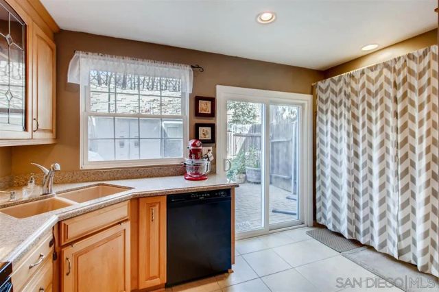 a kitchen with stainless steel appliances granite countertop a sink and a granite counter tops with wooden floors