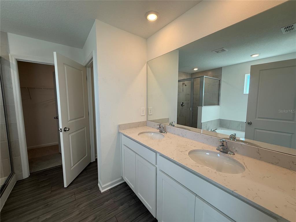 4701 Southwest 83rd Loop Ocala, FL 34476 - Photo 7 of 17 a bathroom with a double vanity sink and a mirror