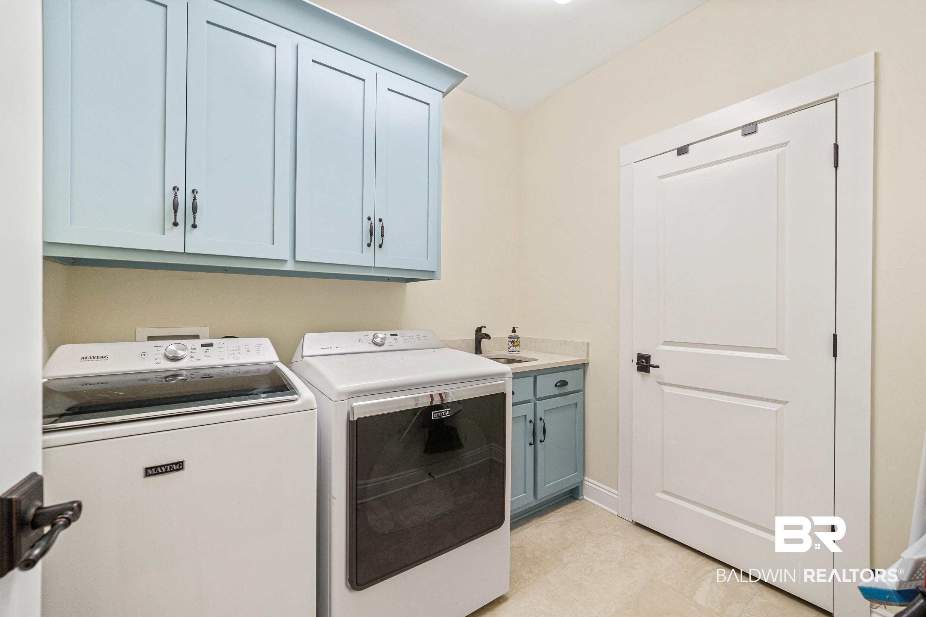 36784 Legacy Way Bay Minette, AL 36507 - Photo 19 of 57 Laundry room with cabinetry, utility sink and large storage closet with shelving.