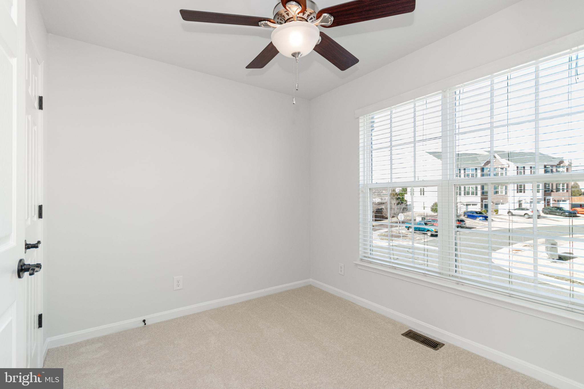 4905 Wensel Road Fredericksburg, VA 22408 - Photo 13 of 23 an empty room with windows and ceiling fan