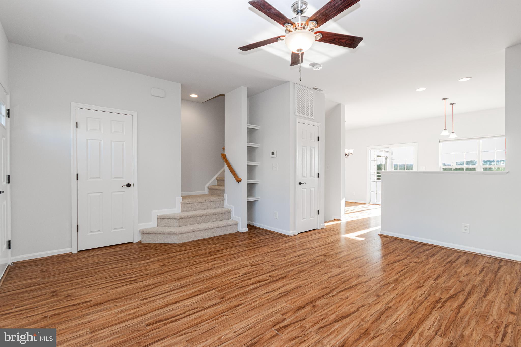 4905 Wensel Road Fredericksburg, VA 22408 - Photo 3 of 23 a view of a room with wooden floor ceiling fan and window
