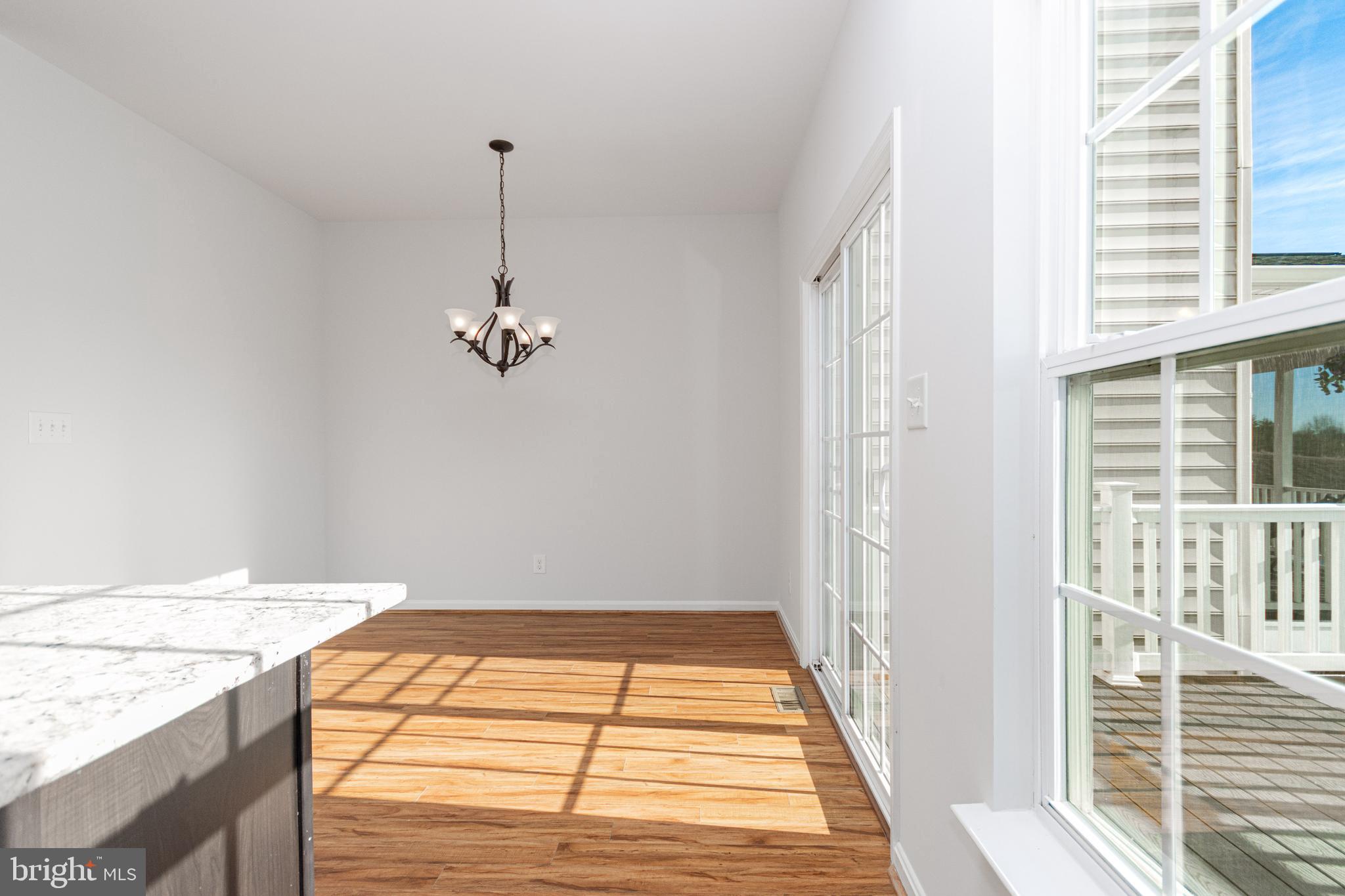 4905 Wensel Road Fredericksburg, VA 22408 - Photo 7 of 23 a view of a room with wooden floor and windows