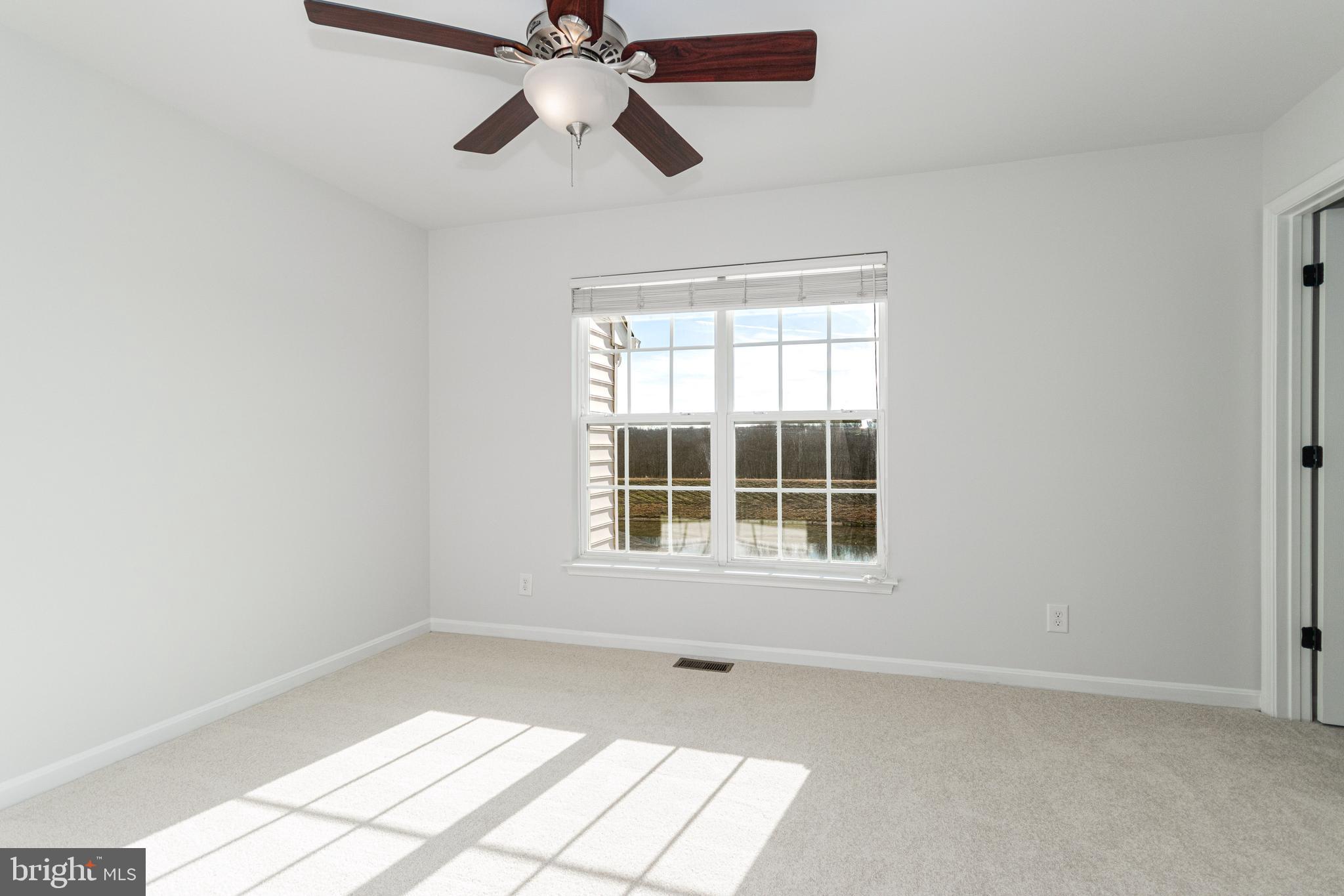 4905 Wensel Road Fredericksburg, VA 22408 - Photo 9 of 23 an empty room with windows and fan