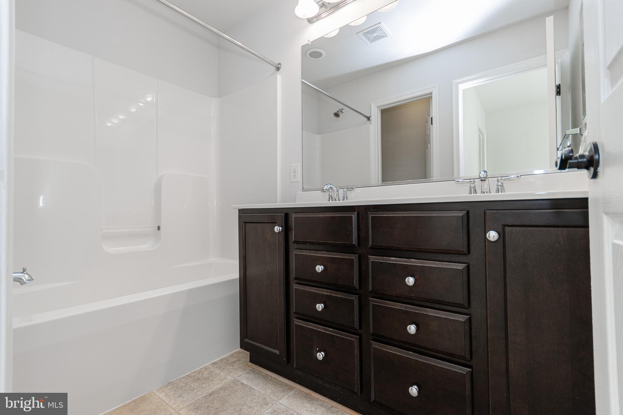 4905 Wensel Road Fredericksburg, VA 22408 - Photo 10 of 23 a spacious bathroom with double vanity and a bathtub