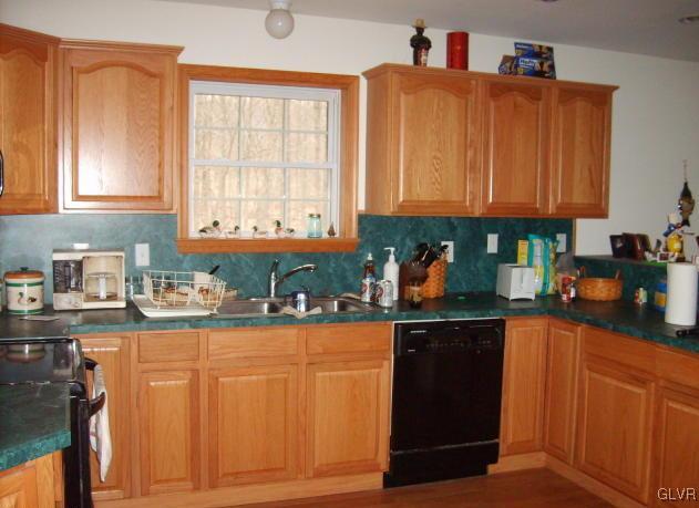 1533 Donaldson Road Cresco, PA 18326 - Photo 5 of 6 a kitchen with granite countertop wooden cabinets and a sink
