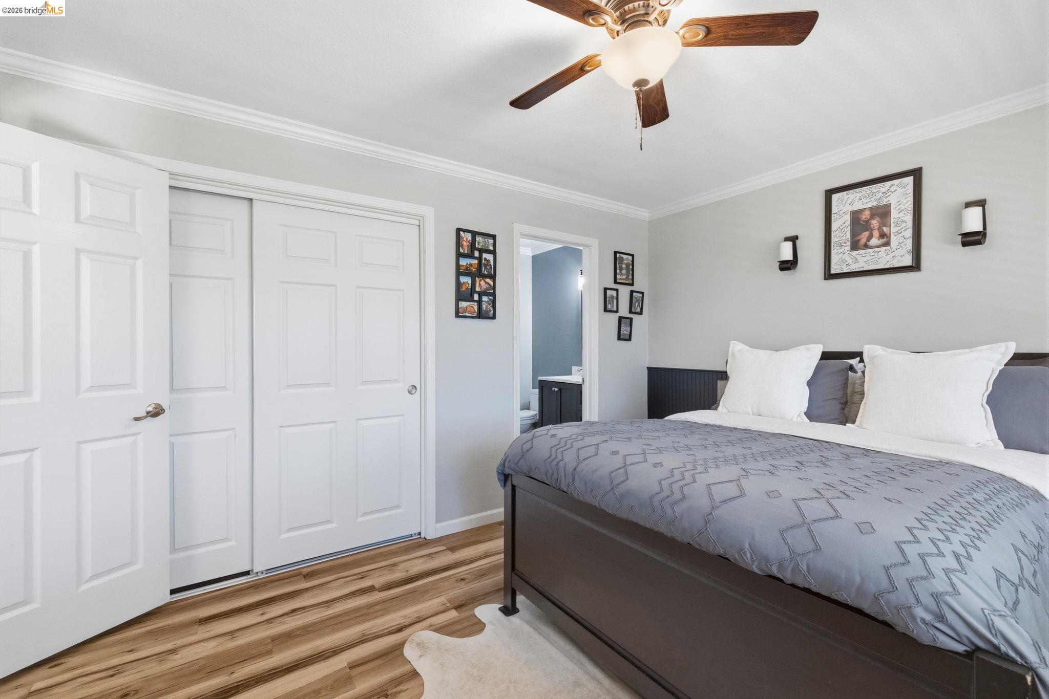 19059 Raboul Court Groveland, CA 95321 - Photo 12 of 21 Bedroom featuring wood-finish flooring, crown molding, a ceiling fan with integrated lighting, and white paneled doors