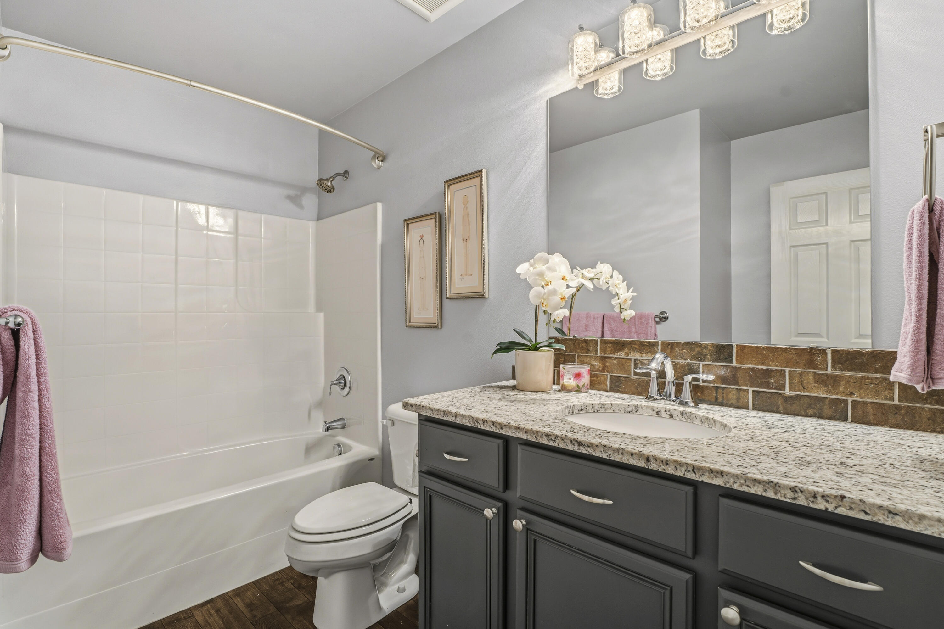 16050 Dick Road La Pine, OR 97739 - Photo 33 of 59 a bathroom with a granite countertop sink toilet mirror and a bathtub