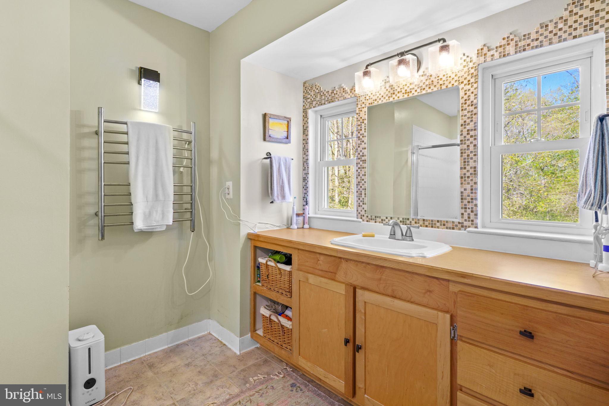 90 Park Avenue Edgewater, MD 21037 - Photo 22 of 44 a bathroom with a sink a mirror and a shower