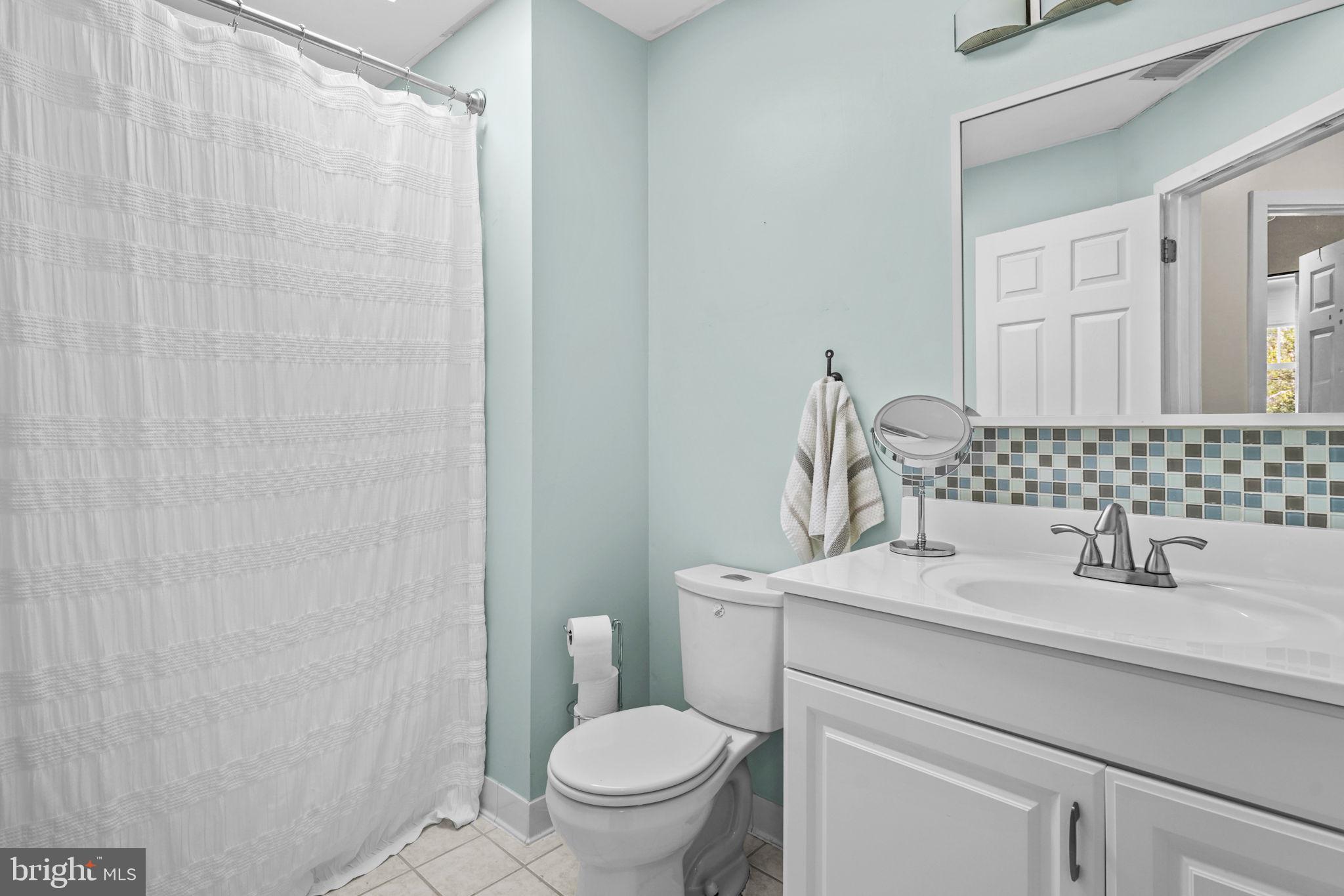 90 Park Avenue Edgewater, MD 21037 - Photo 26 of 44 a bathroom with a sink toilet and a mirror