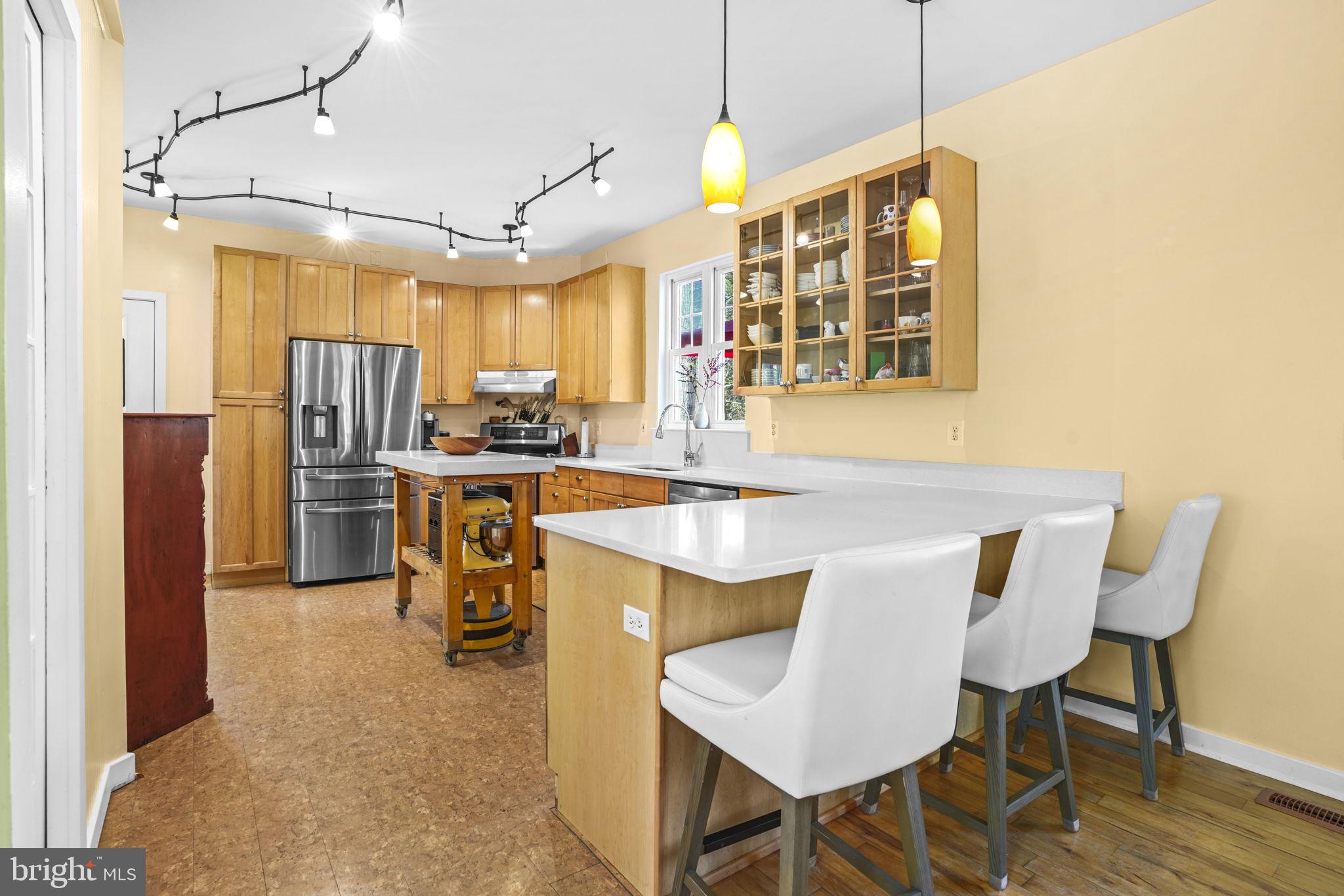 90 Park Avenue Edgewater, MD 21037 - Photo 6 of 44 a kitchen with stainless steel appliances kitchen island granite countertop a table chairs and a refrigerator