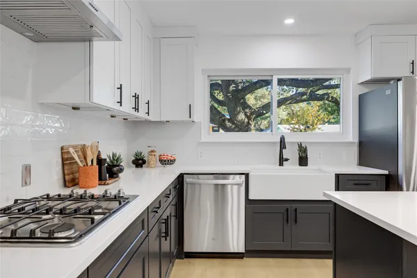 a kitchen with stainless steel appliances a stove and a refrigerator