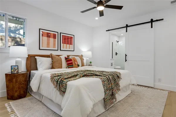a bedroom with a bed and a chandelier